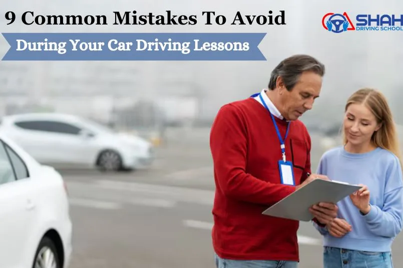 A driving instructor in a red sweater is holding a clipboard and speaking to a young learner driver next to a white car.