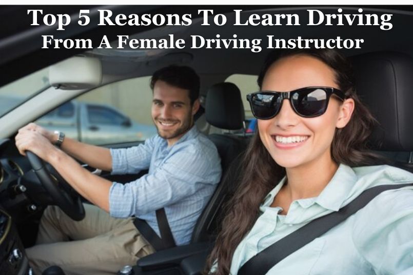 A female driving instructor is sitting in the driver's seat, A man with a beard is sitting in the passenger seat, also smiling.