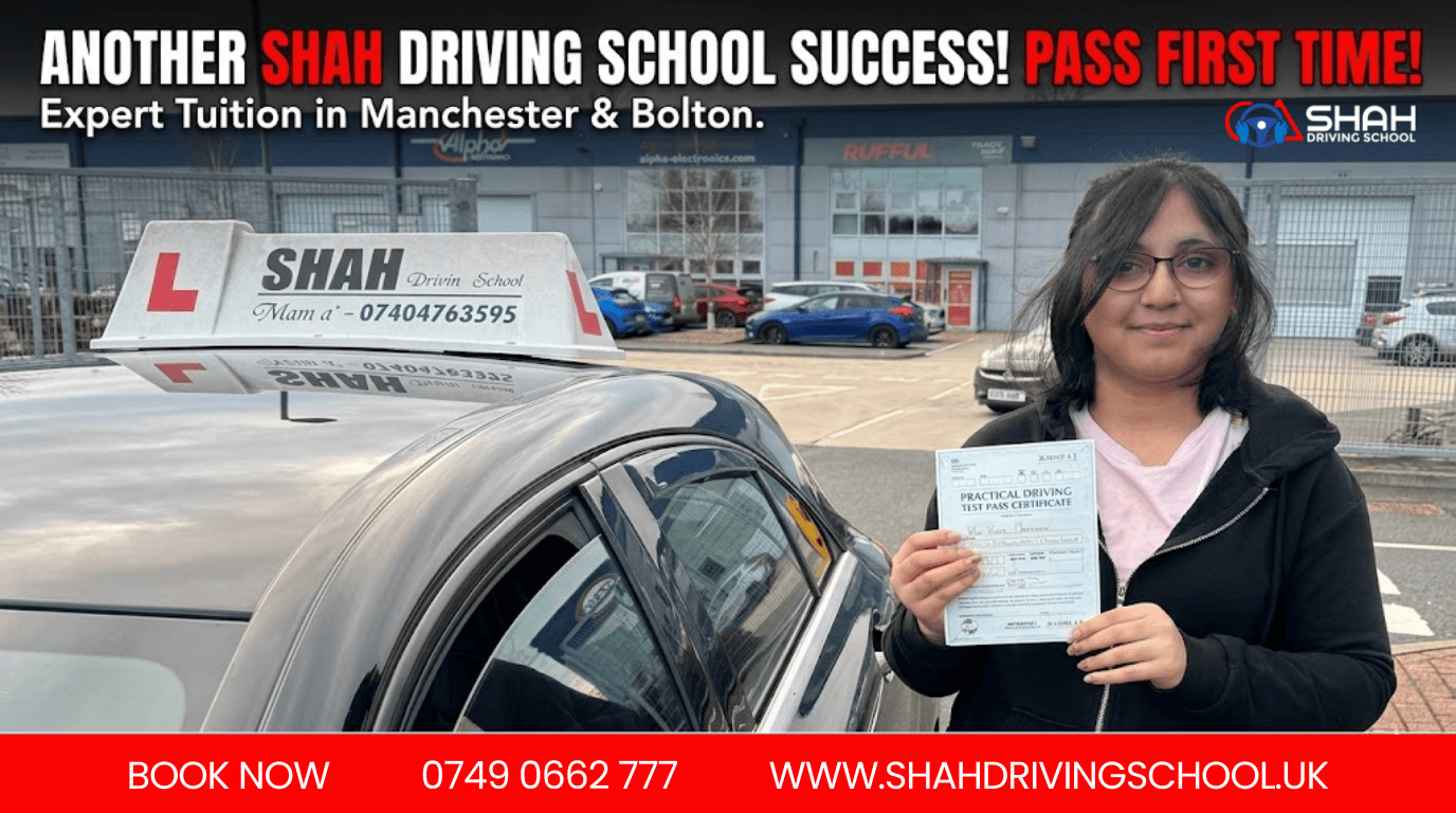 A happy female student wearing glasses and a black tracksuit stands next to a black Shah Driving School car, holding her UK driving test pass certificate. The car roof sign displays 'SHAH Drvin Sc 100l' and the phone number '07404763595'. The industrial estate background includes signs for 'Alpha Electronics' and 'RUFFUL'.