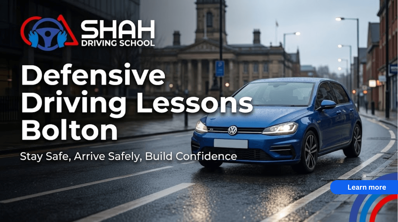 A website blog banner for Shah Driving School featuring a blue Volkswagen car driving on a wet street in Bolton town centre, with text reading "Defensive Driving Lessons Bolton" and the school's logo in the corner.