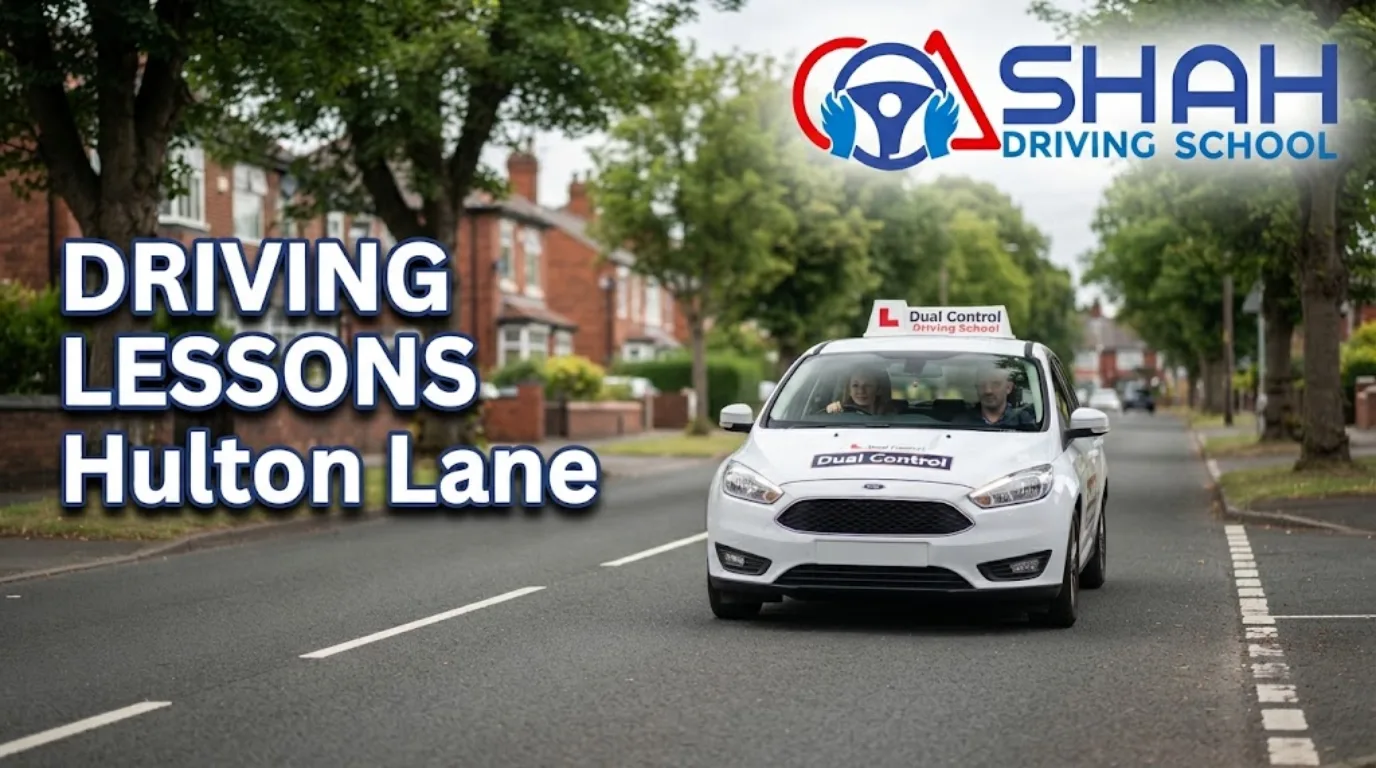 A white dual-control driving tuition car driving down a residential street in Hulton Lane, featuring the Shah Driving School logo and the bold text "Driving Lessons Hulton Lane