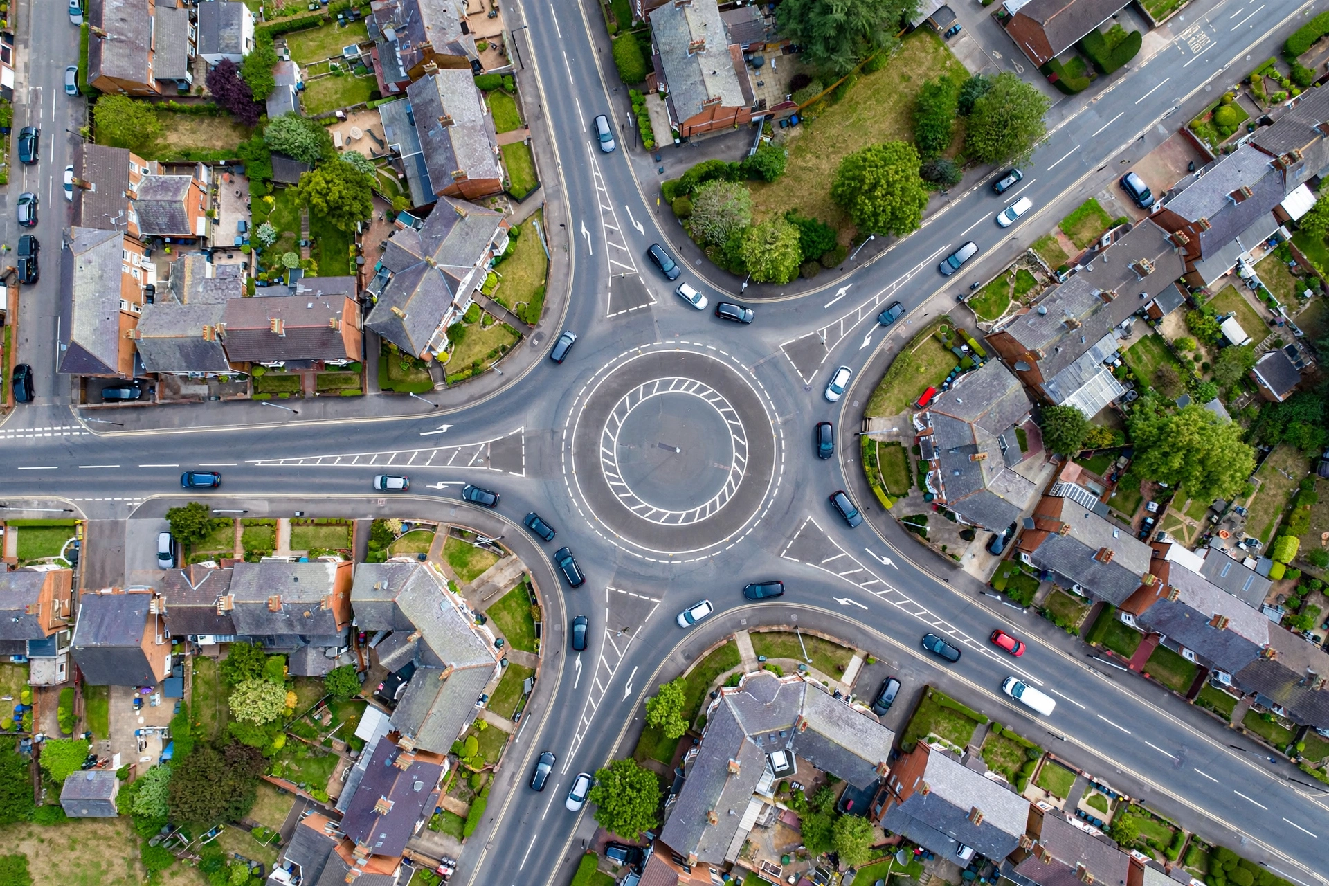 Aerial view of a busy multi-exit roundabout like the Crown roundabout Horwich with cars using the correct lanes