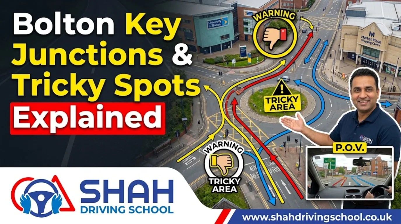 An instructional YouTube thumbnail for Shah Driving School featuring an aerial view of the complex St. George's Road/Topp Way junction in Bolton. A smiling instructor is pointing to the map, which includes the University of Bolton and Market Place Shopping Centre. Warning icons and color-coded arrows (red for complex paths, yellow for warnings, blue for correct routes) highlight "Tricky Areas," with the text "Bolton Key Junctions & Tricky Spots Explained." The Shah Driving School logo is in the corner.